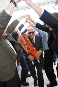 Lee Samson holds one of the sifrei Torah amid the celebrating crowd
