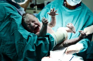 Doctor holding new born