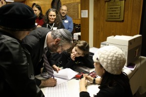 Rabbi Moshe Shulman of Young Israel of St Louis, signs the postnup with his wife, Baila Shulman. (Rori Picker Neiss) 