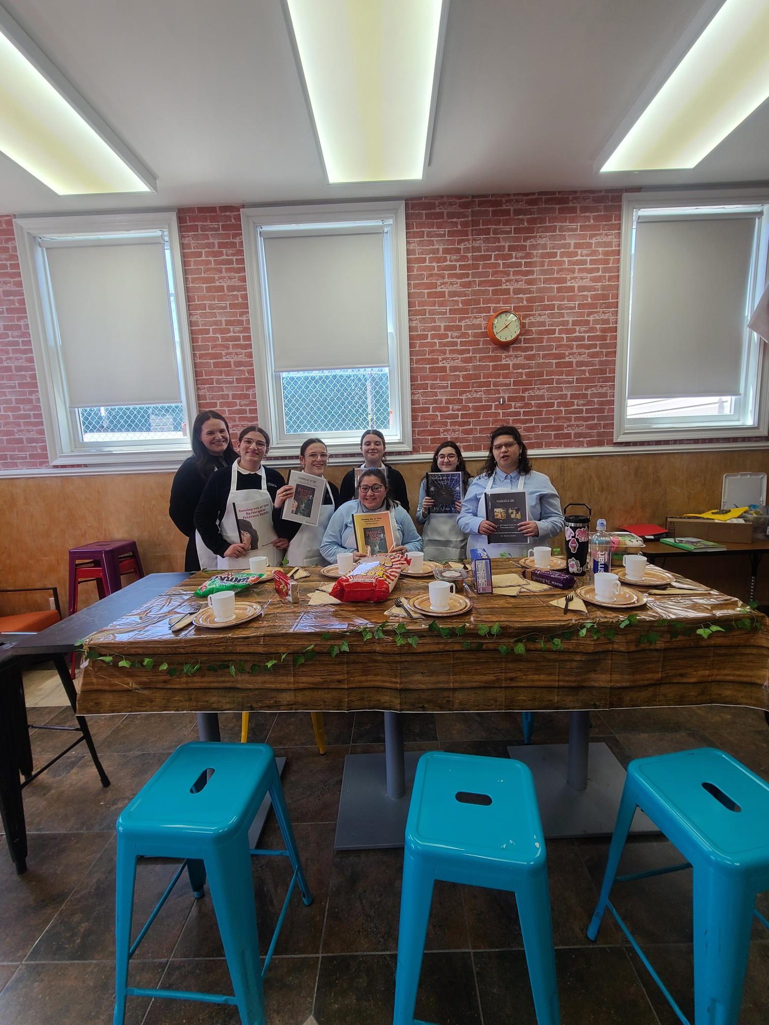 Students share their book reports as part of a book club.