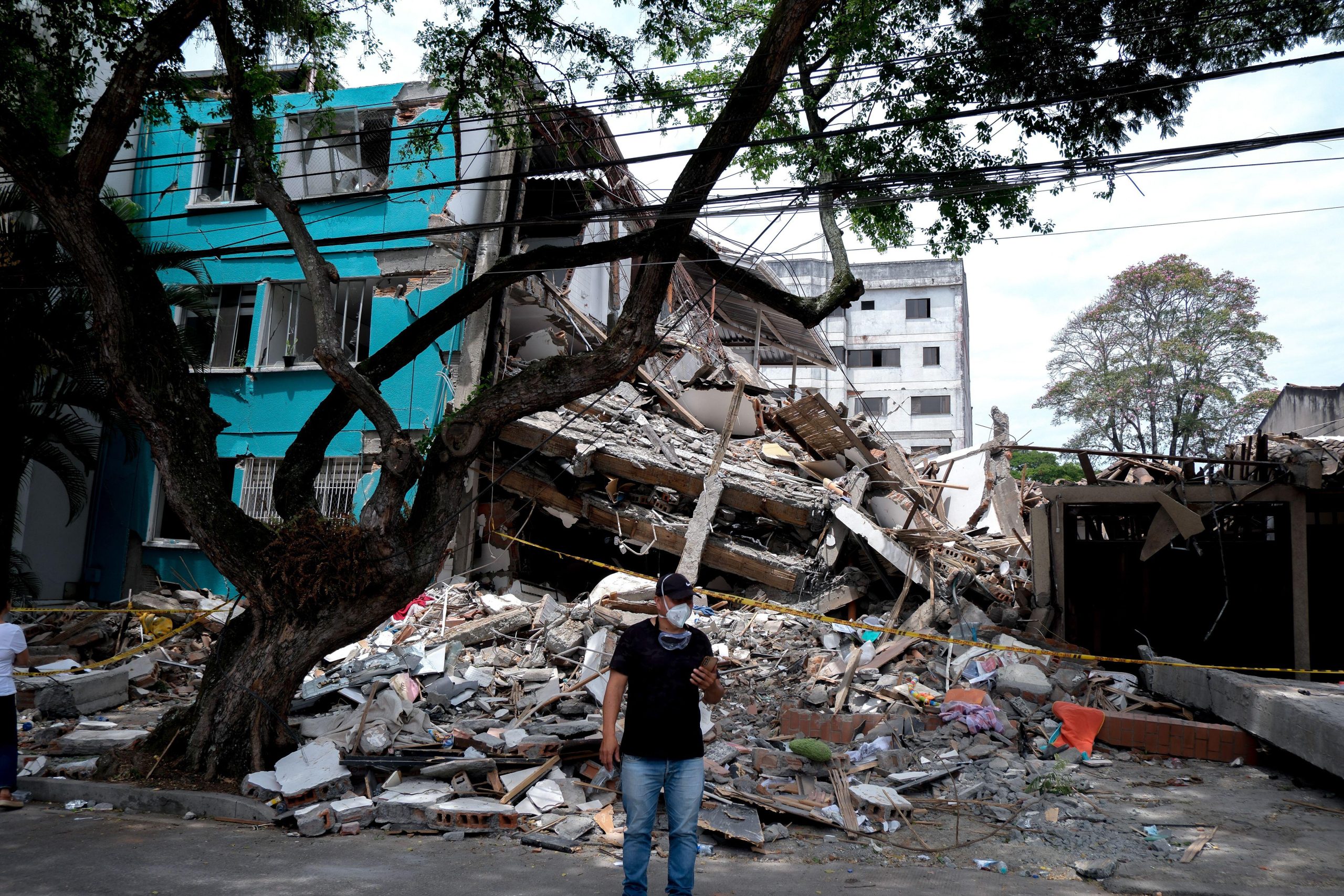 Cali, Colombia. 12th Aug, 2026. People gather outside collapsed buildings in Cali, Colombia on August 12, 2026 to aid in several rescue labors after a 7, 4 magnitude earthquake that struck the cities of Quibdo, Cali, Pereira and Manizales leaving more tha