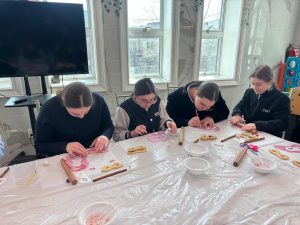 Students participate in a cookie-decorating class.