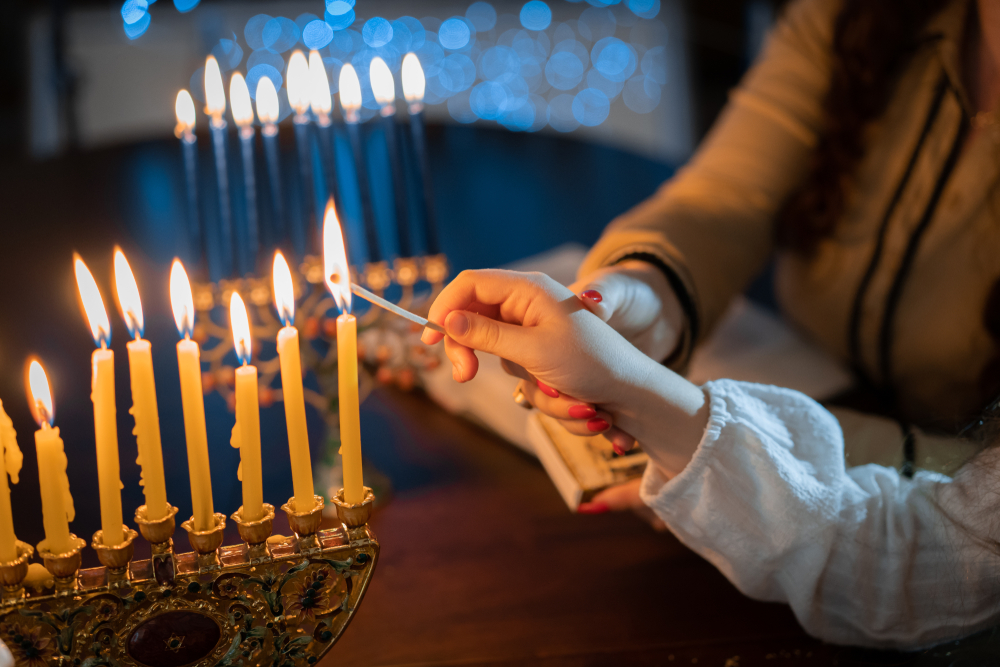 How long must the Chanukah candles remain lit?