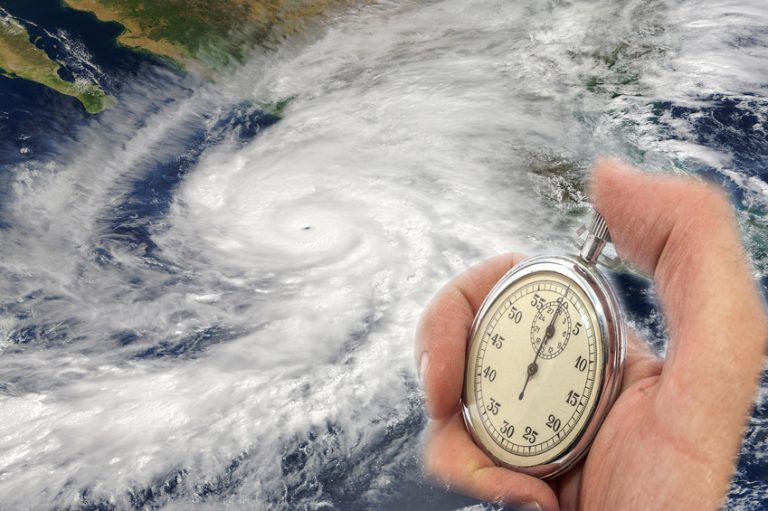 Hurricane Patricia and Hand Holding old Stopwatch. Concept of Climate change. Elements of this image furnished by NASA