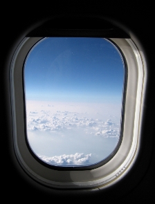 Airplane window view -- clouds, sky
